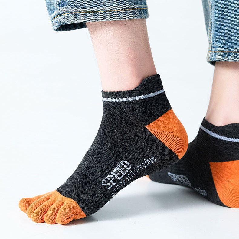 Person wearing black and orange socks with 'SPEED' branding on a light gray background