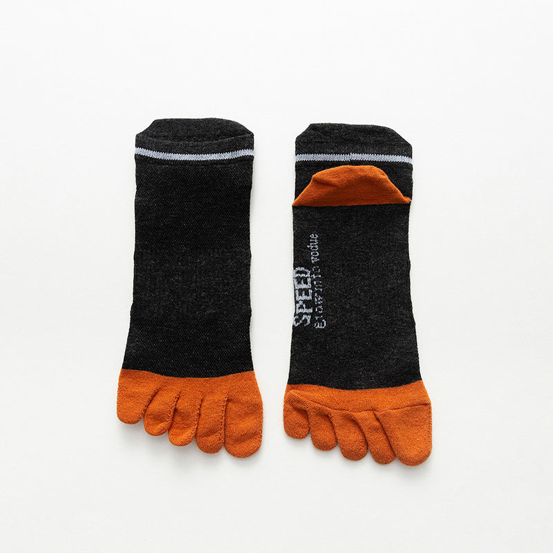 Pair of black and orange toe-separated socks on a white background