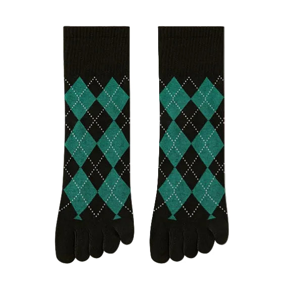 Pair of black and green argyle patterned socks on a beige background
