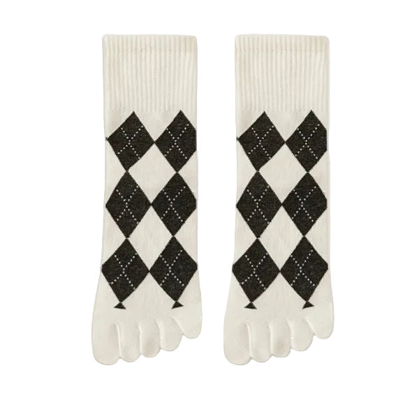 Pair of white socks with black argyle pattern on a light gray background