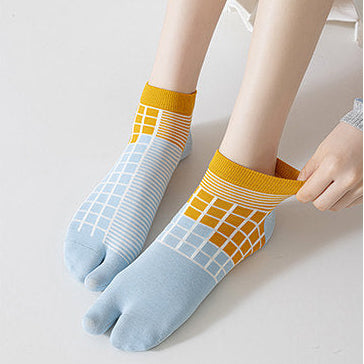 Two pairs of colorful socks worn by models on a plain background