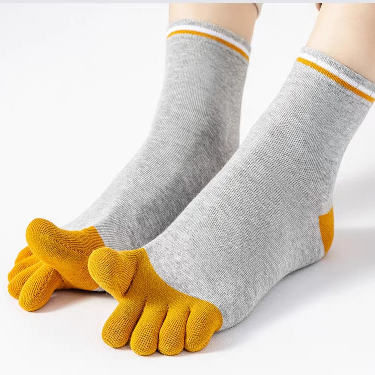 A pair of gray five-toe socks with mustard yellow toes and yellow striped cuffs, shown on a person's feet against a clean white background.