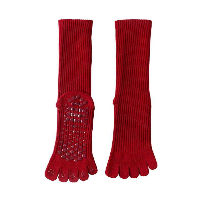 Red five-finger socks with textured sole on a light gray background