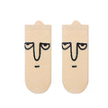 Beige socks with face design on a white background