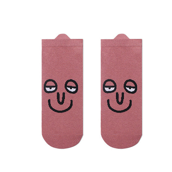 Pink socks with smiley face design on a white background