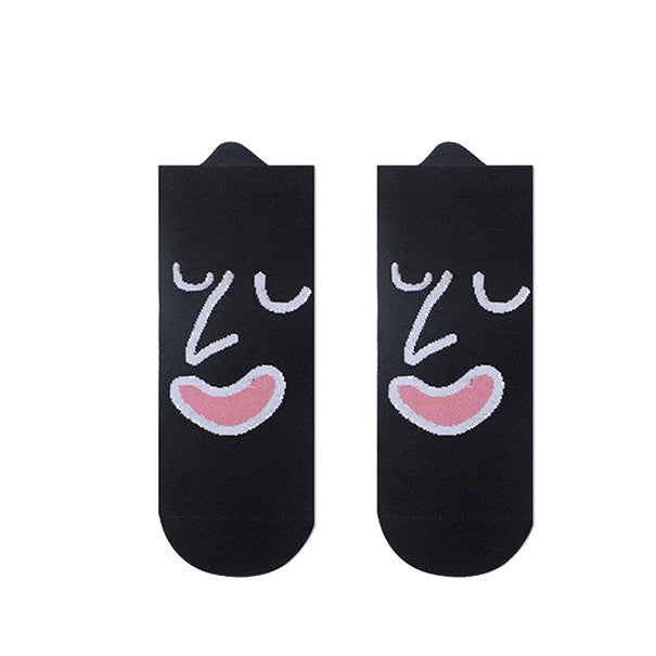 Black socks with face design on a white background