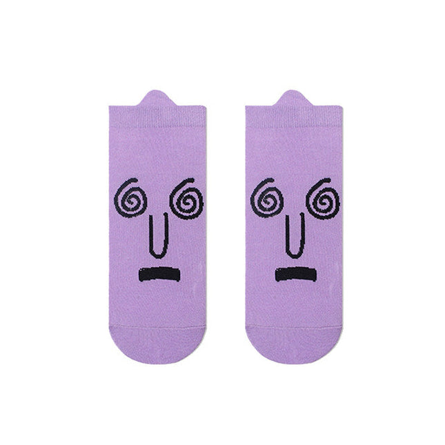 Purple socks with face design on a white background