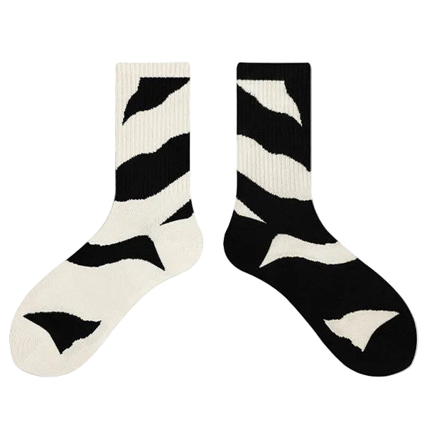 Black and white zebra-striped socks with a white background.