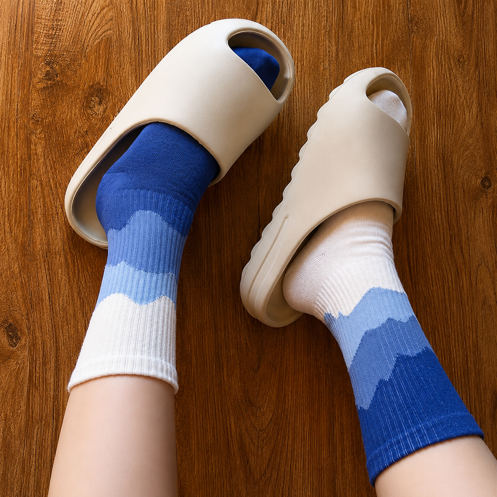 Beige slippers with blue and white socks on a wooden floor