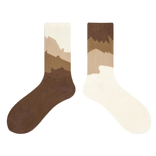 Two socks with a mountain design on a plain background