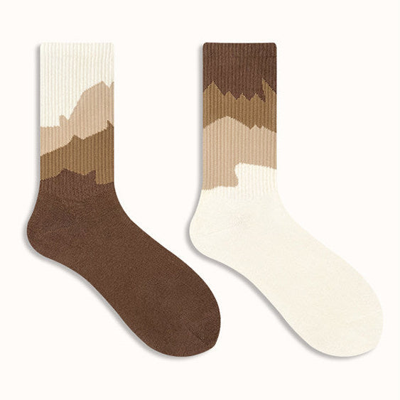 Two socks with a gradient design on a plain background