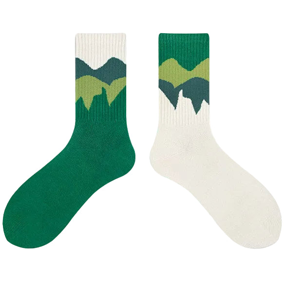 Green and white socks with mountain design on a white background, 