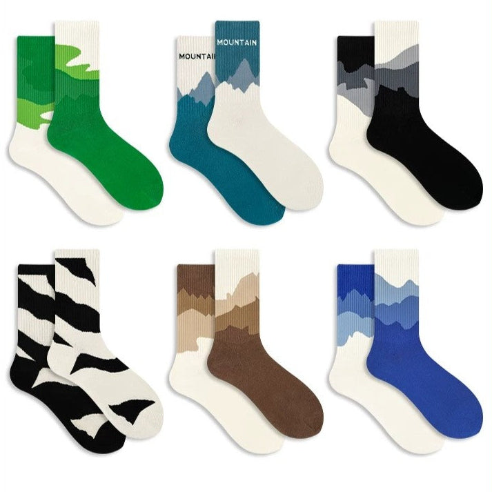 Set of mountain-themed socks in various colors on a white background