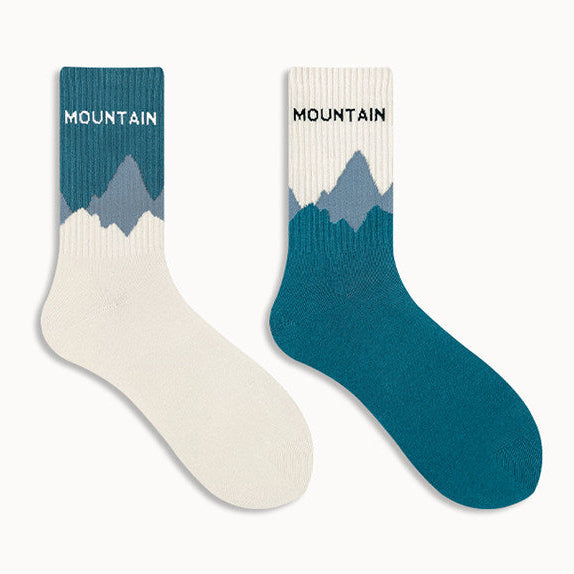 Two mountain-themed socks on a white background.