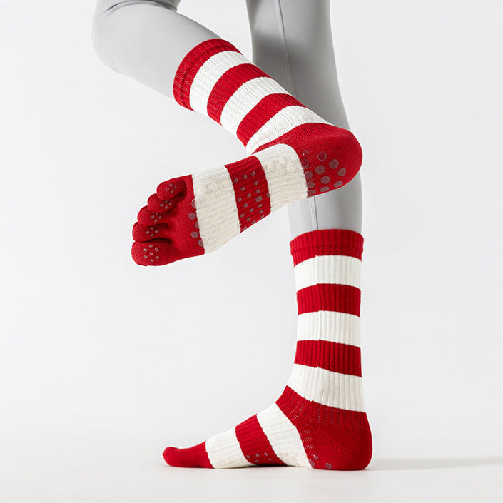 Red and white striped socks worn with gray leggings on a white background
