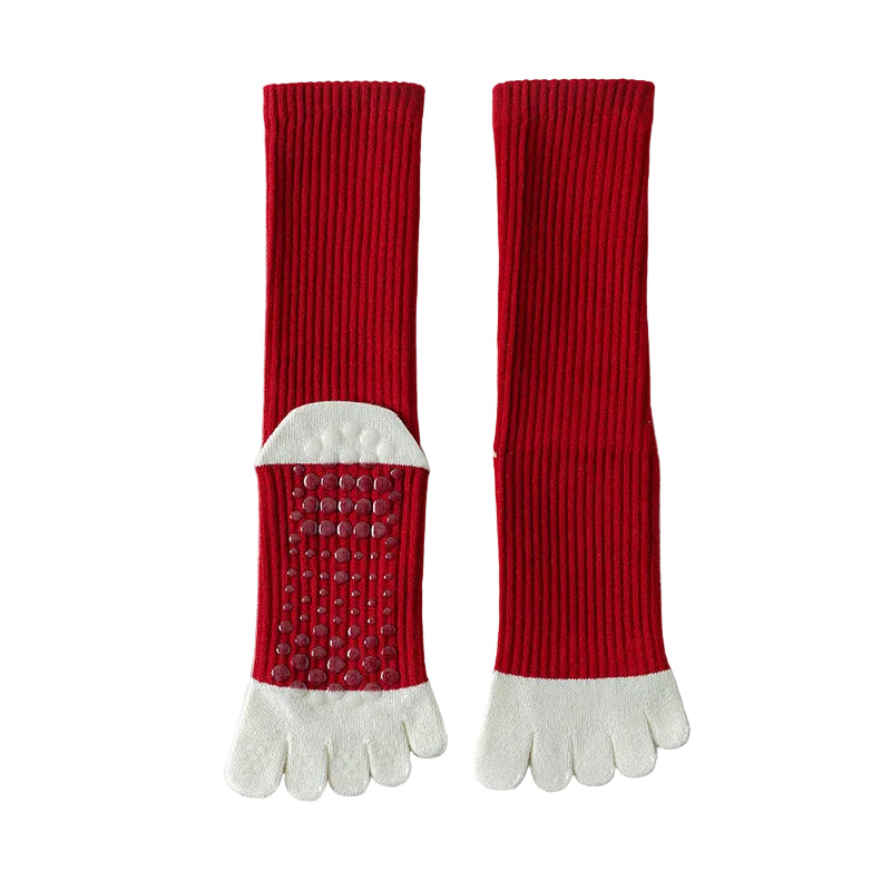 Red and white toe socks on a light gray background