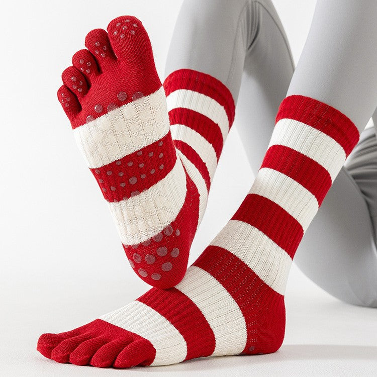 Red and white striped toe socks with grip dots on a light gray background