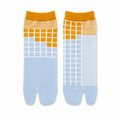 Pair of tabi socks with orange tops and blue patterns on a white background