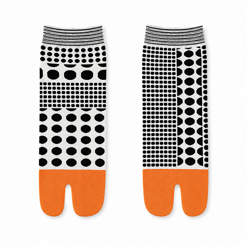 Two pairs of socks with black and white patterned tops and orange toes on a white background