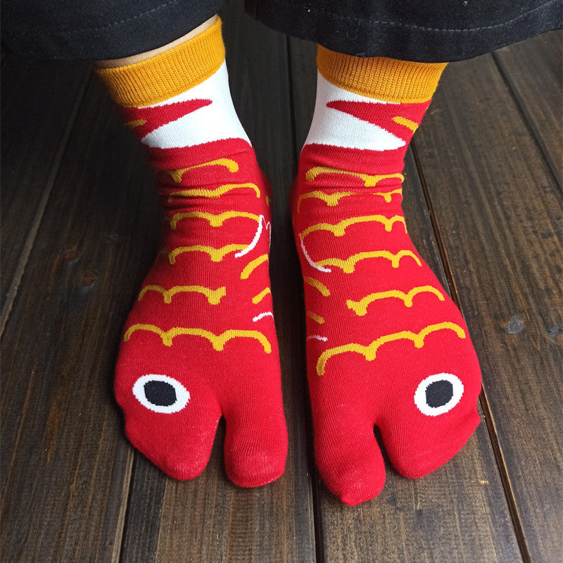 Red and yellow patterned socks on a wooden floor