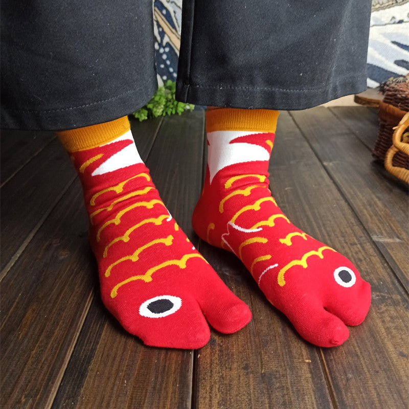 Red socks with fish design worn on a wooden floor