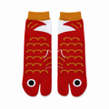 Red tabi socks with gold patterns on a white background